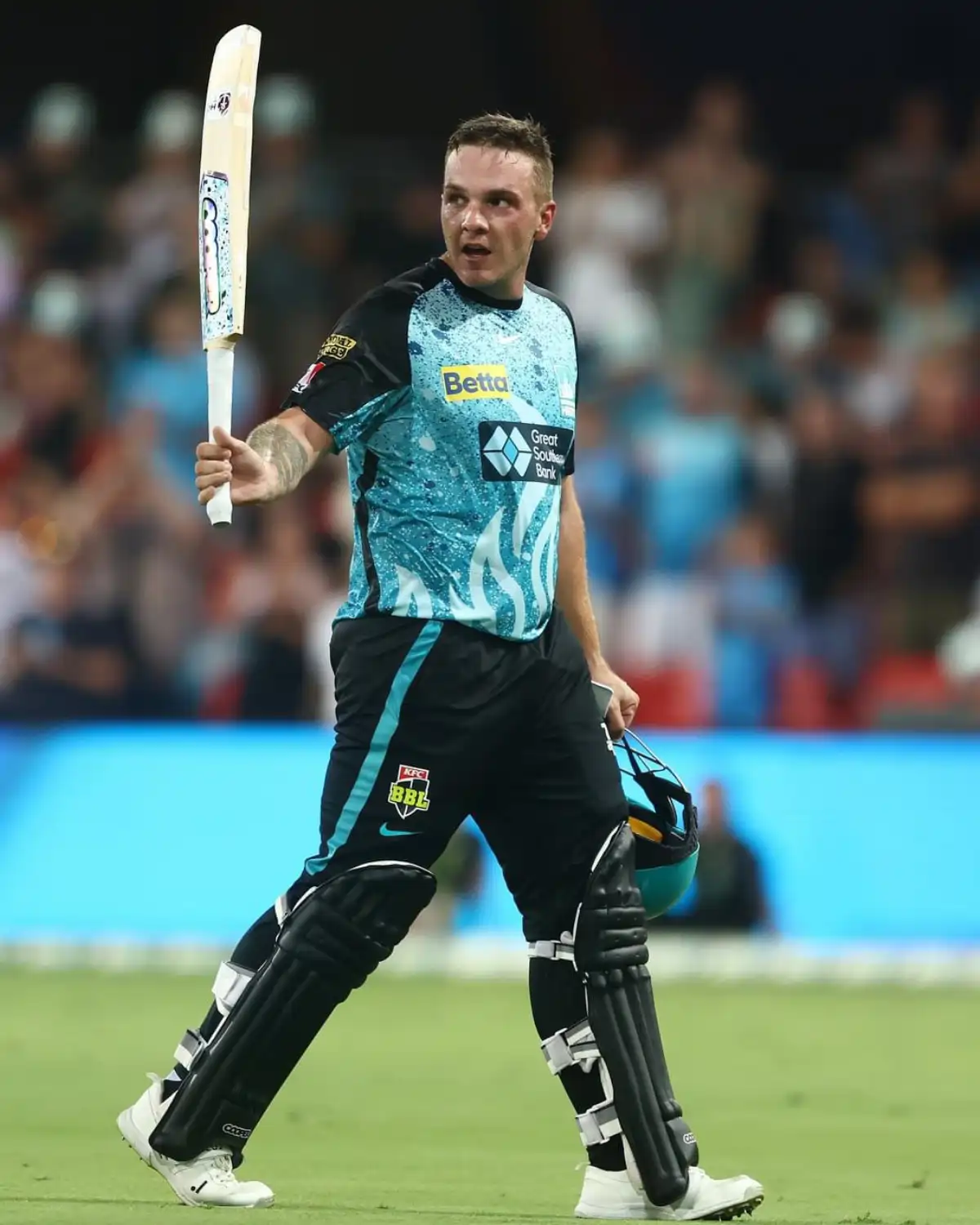 Josh Brown raising his bat to the crowd